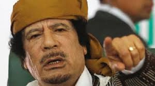 علاقتة بالقذافي
